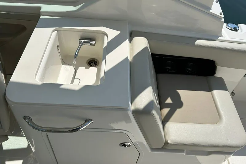 2023 Boston Whaler 280 Vantage @ Puerto Vallarta Yacht Photos Pics 2023 Boston Whaler 280 Vantage boat interior with sink and seating area.