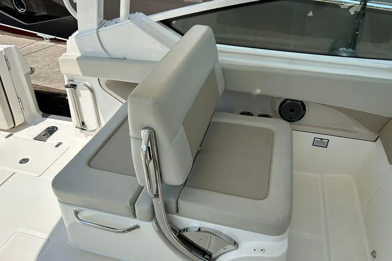 2023 Boston Whaler 280 Vantage @ Puerto Vallarta Yacht Photos Pics 2023 Boston Whaler 280 Vantage boat interior with cushioned seating and stainless steel accents.