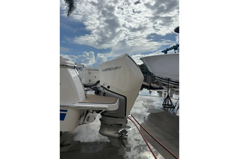 Chasing Palooza Yacht Photos Pics 2024 Southport 30 FE boat with Mercury outboard engine under a cloudy sky.