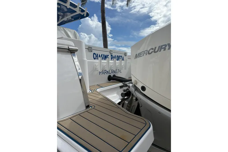 Chasing Palooza Yacht Photos Pics 2024 Southport 30 FE boat with Mercury engine, docked under a blue sky.
