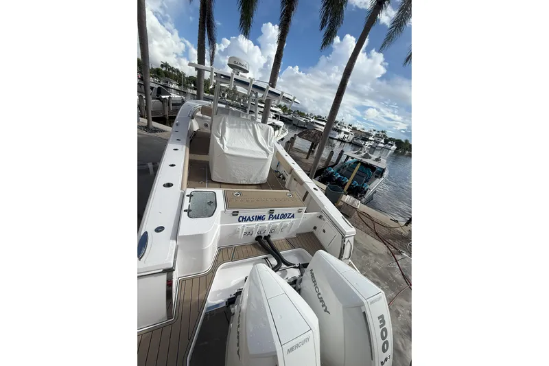 Chasing Palooza Yacht Photos Pics 2024 Southport 30 FE boat docked, featuring twin Mercury engines and a spacious deck.