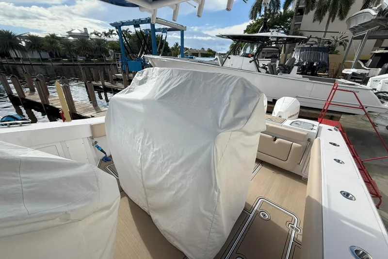 Chasing Palooza Yacht Photos Pics 2024 Southport 30 FE boat interior with covered equipment at a marina.