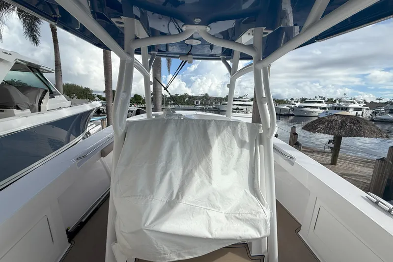 Chasing Palooza Yacht Photos Pics 2024 Southport 30 FE boat interior with covered seating, docked at a marina.