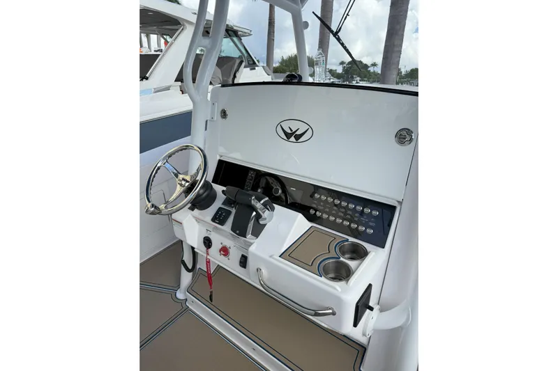 Chasing Palooza Yacht Photos Pics 2024 Southport 30 FE boat helm with steering wheel and control panel.