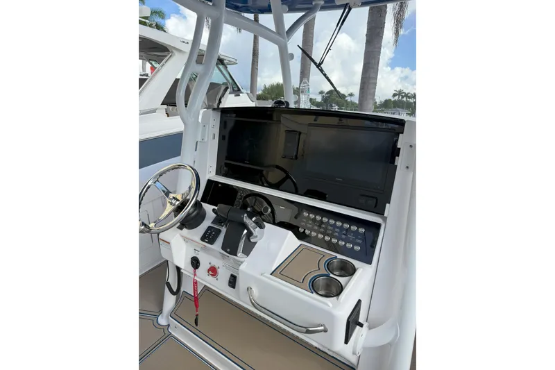 Chasing Palooza Yacht Photos Pics 2024 Southport 30 FE boat helm with steering wheel and control panel.