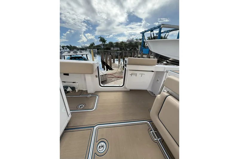 Chasing Palooza Yacht Photos Pics 2024 Southport 30 FE boat interior with tan seating and open deck view.