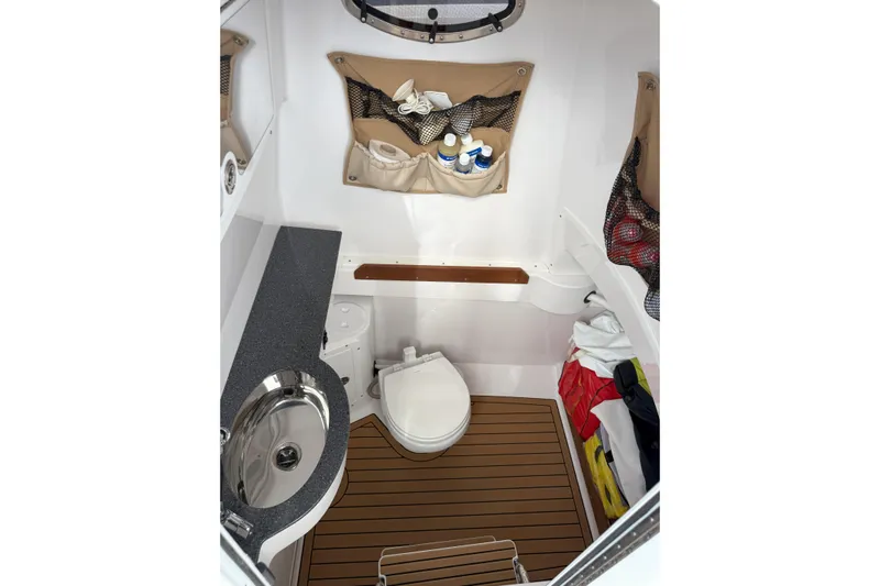 Chasing Palooza Yacht Photos Pics 2024 Southport 30 FE boat interior with toilet, sink, and storage compartments.