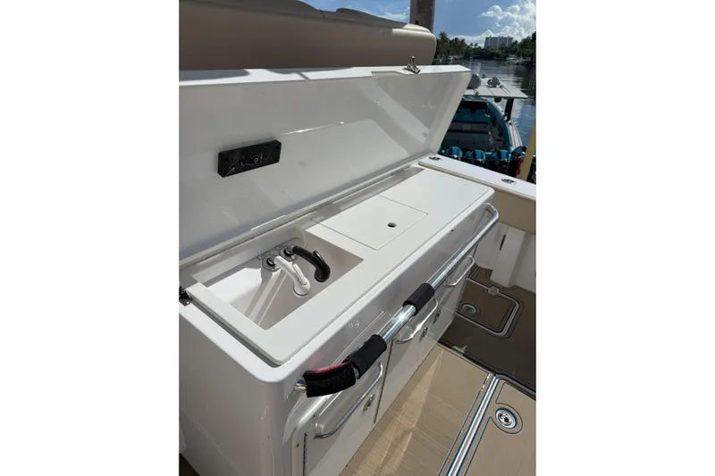 Chasing Palooza Yacht Photos Pics 2024 Southport 30 FE boat with open storage compartment and sink on deck.