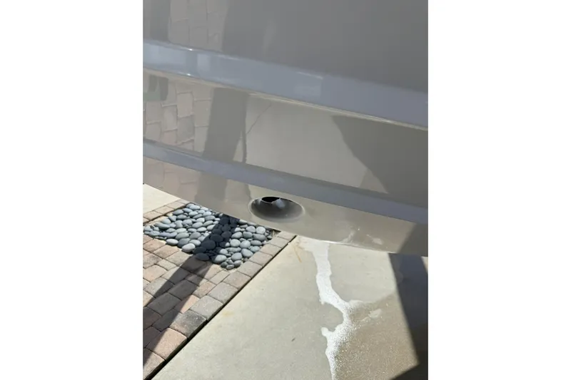 Chasing Palooza Yacht Photos Pics 2024 Southport 30 FE boat hull detail with drain plug, outdoor setting.