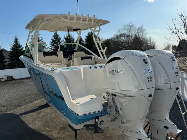  Yacht Photos Pics 2024 Sailfish 276 DC boat with dual Yamaha engines, parked outdoors.