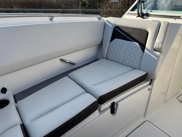  Yacht Photos Pics 2024 Sailfish 276 DC boat interior with cushioned seating and modern design.