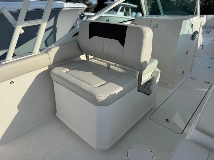  Yacht Photos Pics 2024 Sailfish 276 DC boat interior seating with cushioned bench and storage.