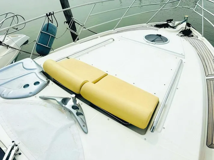  Yacht Photos Pics 2006 Cranchi Mediterranee 47 yacht deck with yellow sunbed and sleek design.