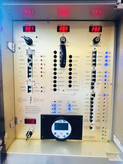  Yacht Photos Pics Electrical control panel of a 2006 Cranchi Mediterranee 47 yacht, featuring various switches and displays.
