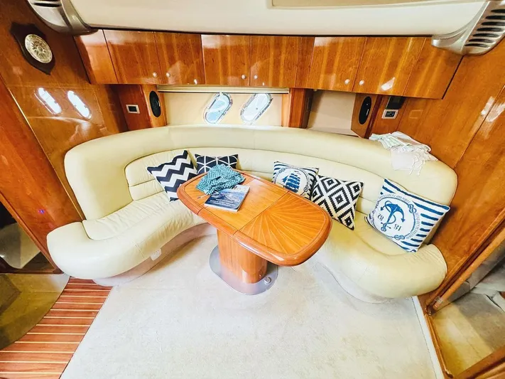  Yacht Photos Pics Luxurious 2006 Cranchi Mediterranee 47 yacht interior with elegant seating and decorative pillows.