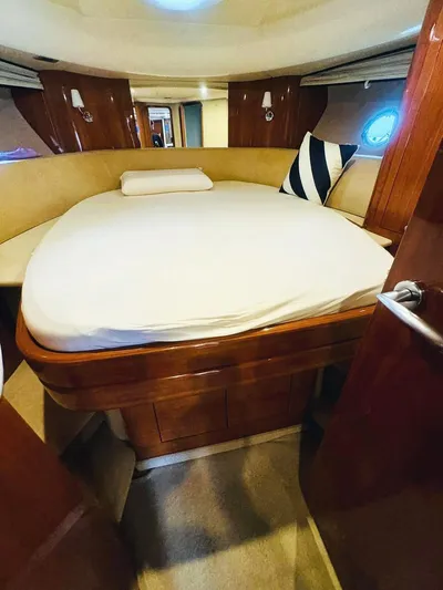  Yacht Photos Pics 2006 Cranchi Mediterranee 47 yacht cabin with cozy bed and elegant wood finish.