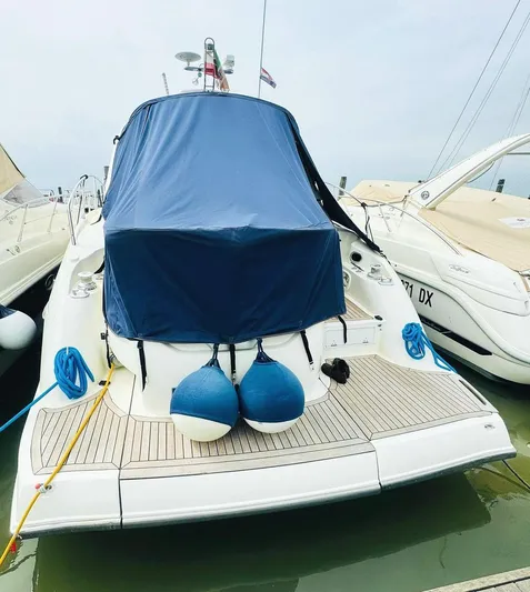  Yacht Photos Pics 2006 Cranchi Mediterranee 47 yacht docked with blue cover and fenders.