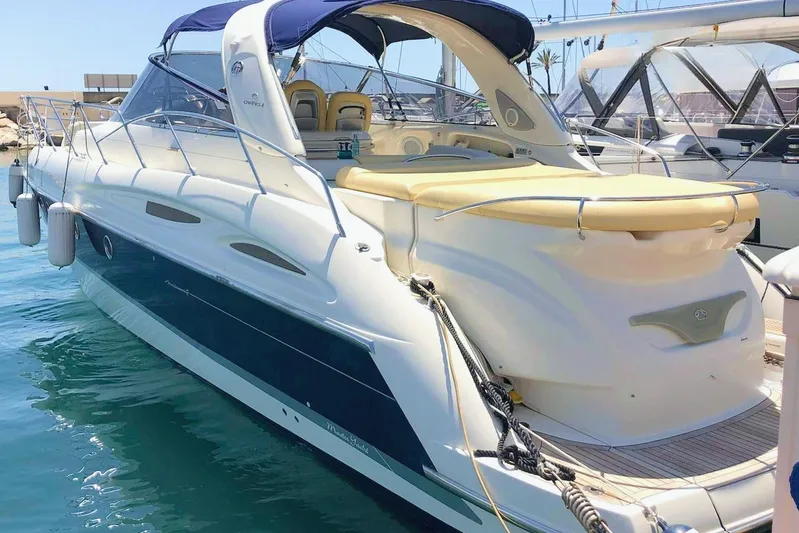  Yacht Photos Pics 2006 Cranchi Mediterranee 47 yacht docked in marina, featuring sleek design and spacious deck.