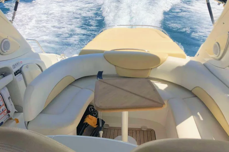  Yacht Photos Pics 2006 Cranchi Mediterranee 47 yacht interior with seating and table, cruising on open water.