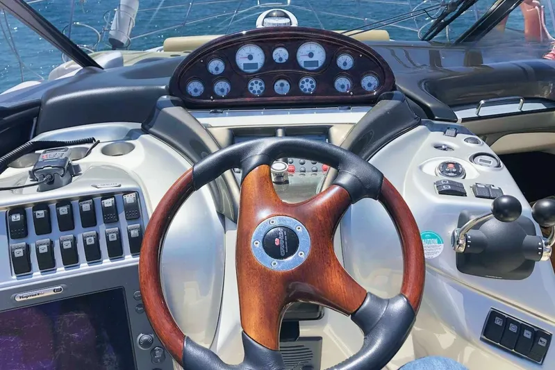  Yacht Photos Pics Cockpit of 2006 Cranchi Mediterranee 47 yacht with wooden steering wheel and control panel.