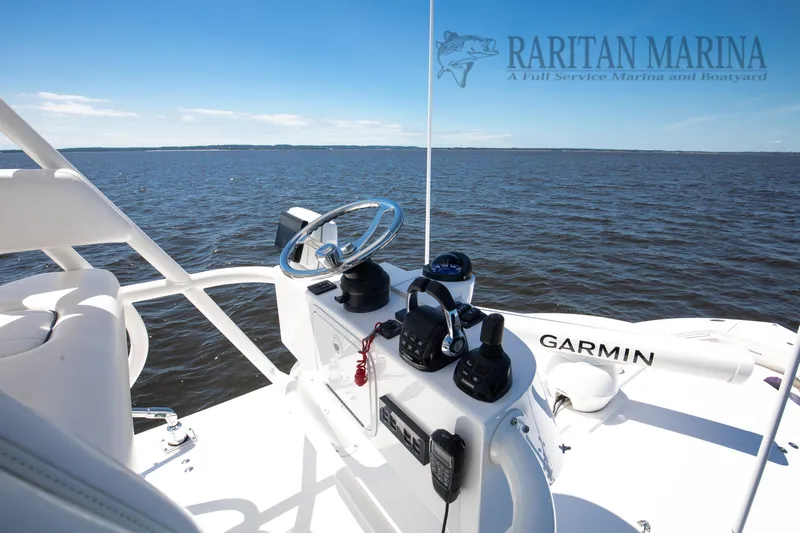  Yacht Photos Pics 2016 Regulator 41 boat helm with Garmin equipment, overlooking calm waters.