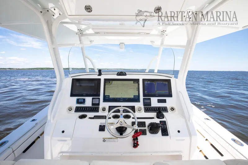  Yacht Photos Pics 2016 Regulator 41 boat helm with advanced navigation systems on open water.