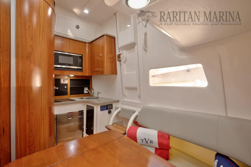 Yacht Photos Pics Luxurious interior of 2016 Regulator 41 boat with kitchenette and seating area.