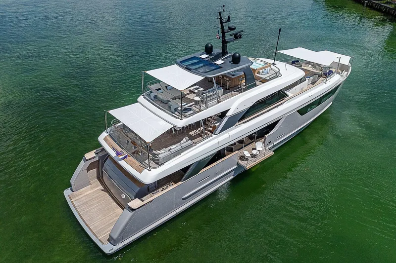 The Wolf Yacht Photos Pics Luxurious 2023 Sanlorenzo SD118 yacht on calm green water, showcasing elegant design.
