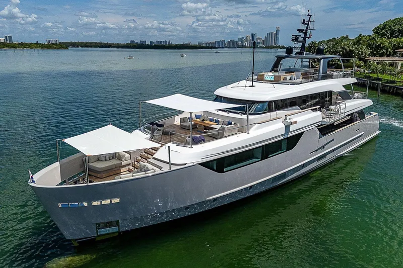 The Wolf Yacht Photos Pics Luxurious 2023 Sanlorenzo SD118 yacht cruising on a serene waterway.