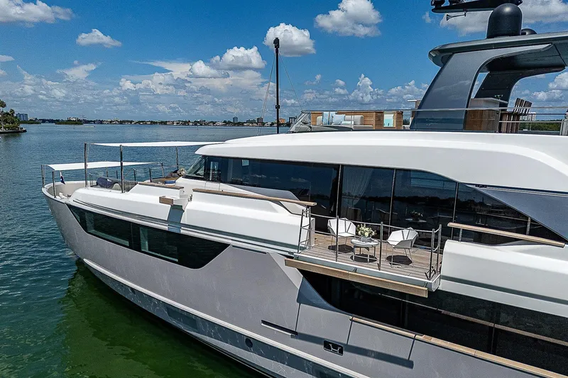 The Wolf Yacht Photos Pics Luxurious 2023 Sanlorenzo SD118 yacht on serene water under a clear blue sky.