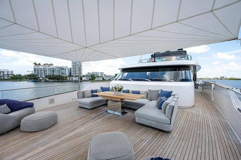 The Wolf Yacht Photos Pics Luxurious 2023 Sanlorenzo SD118 yacht deck with elegant seating and waterfront view.