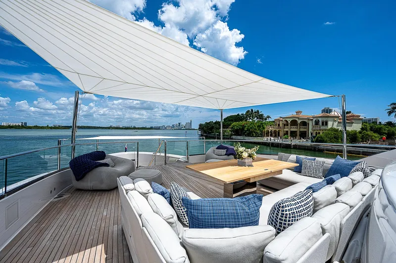 The Wolf Yacht Photos Pics Luxurious 2023 Sanlorenzo SD118 yacht deck with elegant seating and scenic waterfront view.
