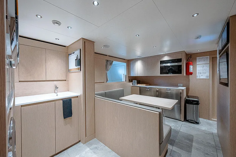 The Wolf Yacht Photos Pics Modern interior of 2023 Sanlorenzo SD118 yacht with sleek kitchen and dining area.