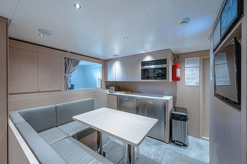 The Wolf Yacht Photos Pics Modern interior of 2023 Sanlorenzo SD118 yacht with sleek kitchen and dining area.