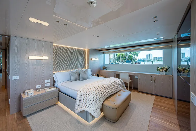 The Wolf Yacht Photos Pics Luxurious 2023 Sanlorenzo SD118 yacht bedroom with modern decor and large window view.