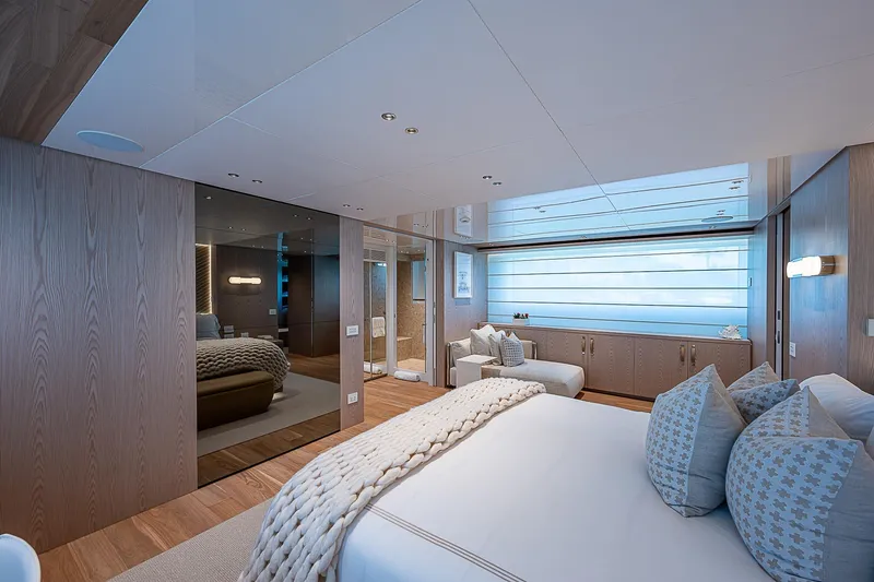 The Wolf Yacht Photos Pics Luxurious Sanlorenzo SD118 2023 yacht bedroom with modern decor and elegant furnishings.