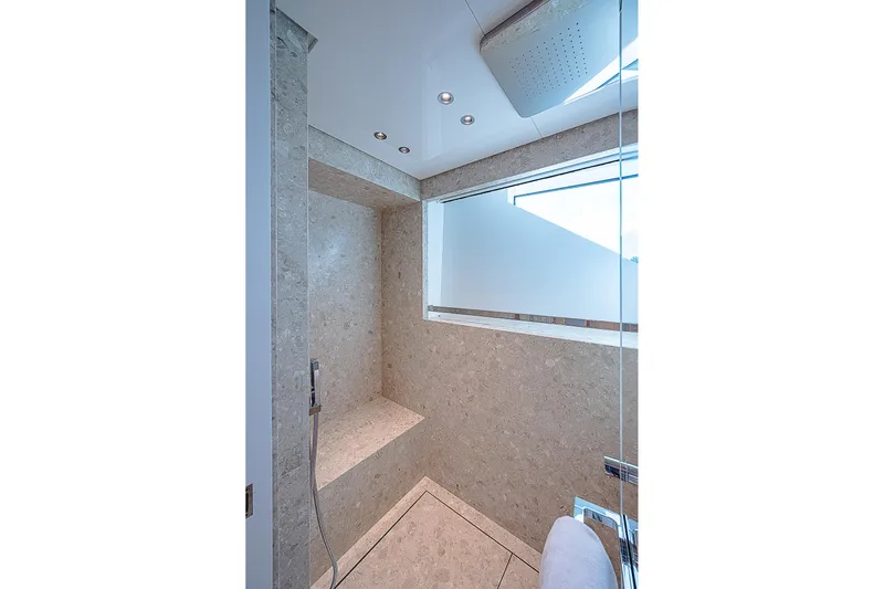 The Wolf Yacht Photos Pics Luxurious shower in 2023 Sanlorenzo SD118 yacht with modern design and elegant stone finish.