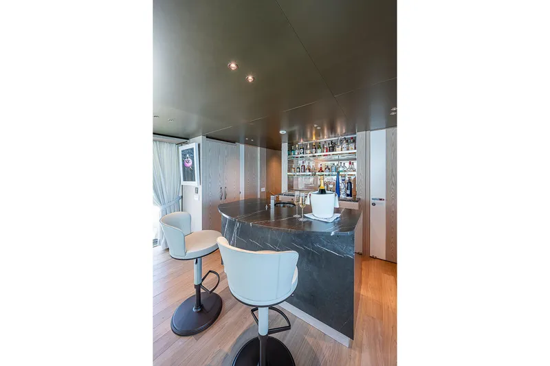 The Wolf Yacht Photos Pics Luxurious bar area on 2023 Sanlorenzo SD118 yacht with modern seating and elegant design.
