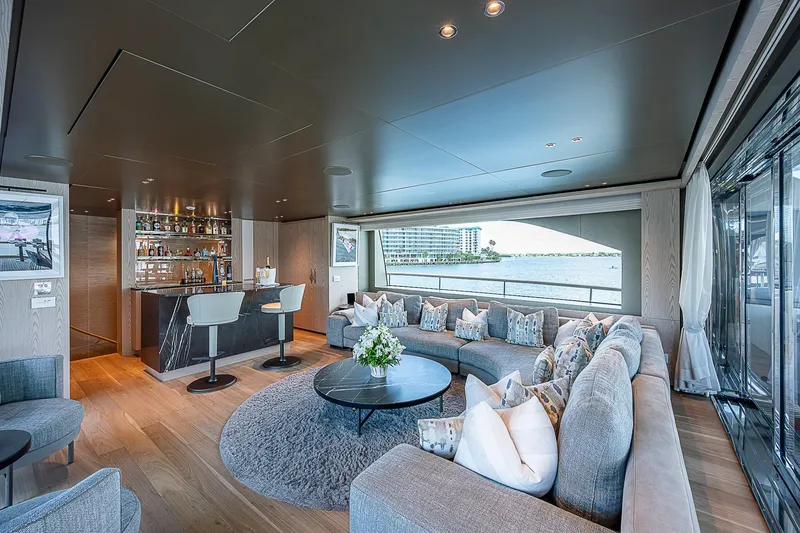 The Wolf Yacht Photos Pics Luxurious interior of 2023 Sanlorenzo SD118 yacht with elegant seating and bar area.