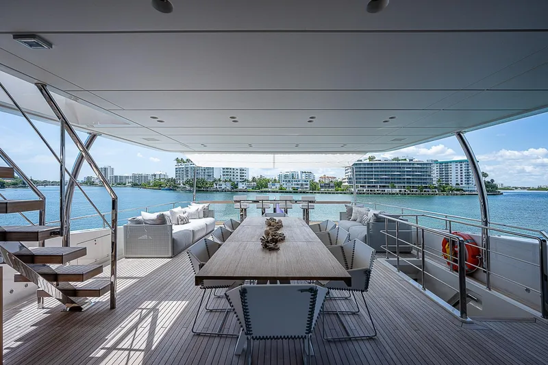 The Wolf Yacht Photos Pics Luxurious 2023 Sanlorenzo SD118 yacht deck with elegant dining area and waterfront view.