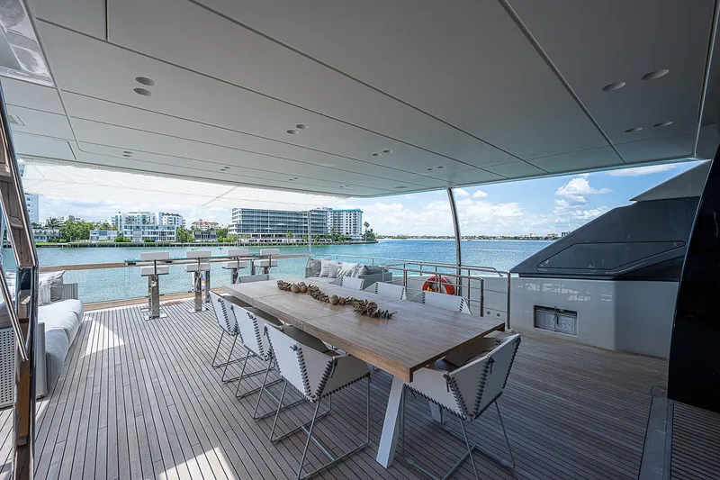 The Wolf Yacht Photos Pics Luxurious 2023 Sanlorenzo SD118 yacht deck with elegant dining area and waterfront view.