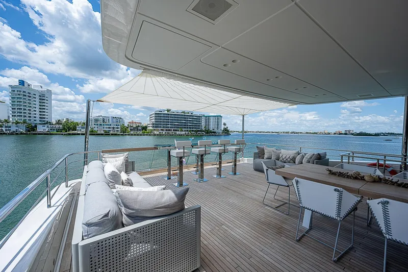 The Wolf Yacht Photos Pics Luxurious 2023 Sanlorenzo SD118 yacht deck with elegant seating and stunning waterfront views.