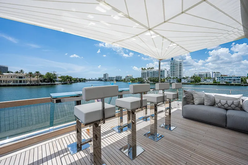 The Wolf Yacht Photos Pics Luxurious 2023 Sanlorenzo SD118 yacht deck with modern seating and waterfront view.