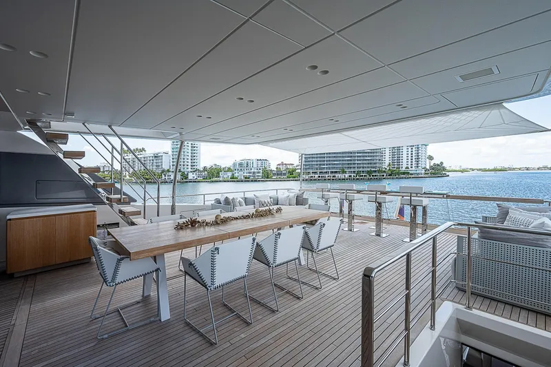 The Wolf Yacht Photos Pics Luxurious 2023 Sanlorenzo SD118 yacht deck with dining area and waterfront view.