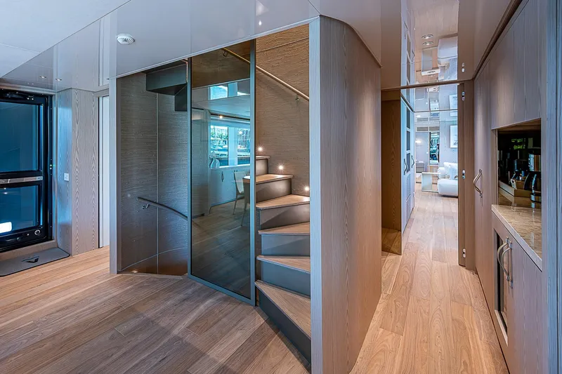 The Wolf Yacht Photos Pics Luxurious interior of 2023 Sanlorenzo SD118 yacht with modern staircase and elegant design.