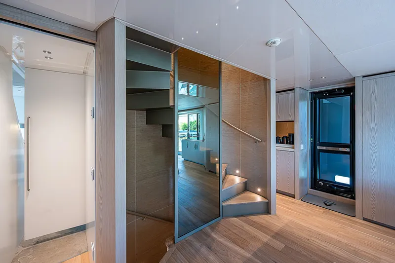 The Wolf Yacht Photos Pics Luxurious interior of 2023 Sanlorenzo SD118 yacht featuring modern staircase and sleek design.