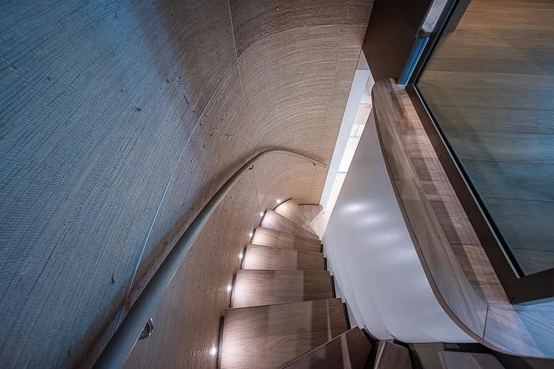 The Wolf Yacht Photos Pics Curved wooden staircase on 2023 Sanlorenzo SD118 yacht interior.
