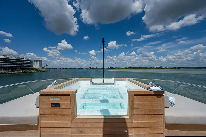 The Wolf Yacht Photos Pics Luxurious Sanlorenzo SD118 yacht with jacuzzi, 2023 model, overlooking serene waters and blue sky.