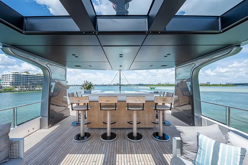 The Wolf Yacht Photos Pics Luxurious 2023 Sanlorenzo SD118 yacht deck with bar stools and ocean view.
