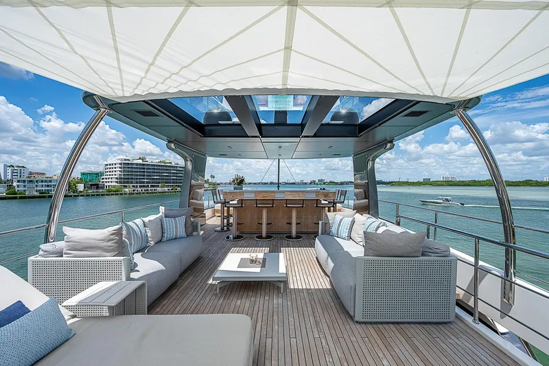The Wolf Yacht Photos Pics Luxurious 2023 Sanlorenzo SD118 yacht deck with elegant seating and scenic waterfront views.